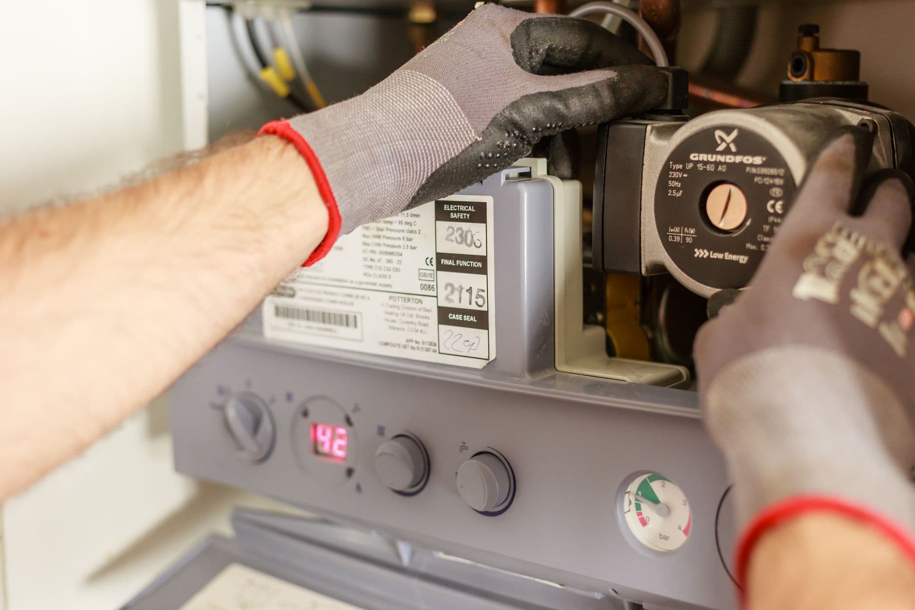 A technician servicing a boiler and heating system