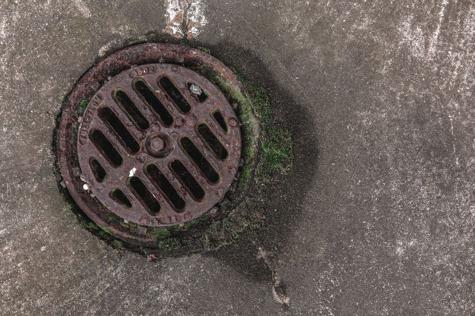A metal floor drain grate